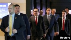 美国财政部长姆努钦(中)和美国经贸代表团成员离开北京一家酒店前去与中方谈判人员举行贸易谈判。(2018年5月3日)