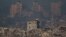 Bangunan-bangunan yang hancur tampak di Jalur Gaza, terlihat dari Israel selatan pada 20 November 2023. (AP Photo/Leo Correa)