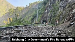 This handout photo from the Taichung City Government's Fire Bureau taken and released on April 3, 2024 shows rocks along part of the road on a section of a highway in Taichung, after a major earthquake hit Taiwan's east.