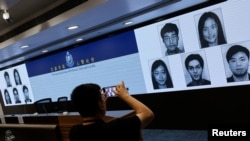 香港当局在记者会上公布被通缉的五名活动人士的照片资料。(2023年12月14日)