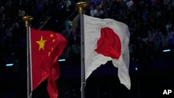 资料照片:中国杭州亚运会上飘扬着中日两国国旗。(2023年10月8日)
