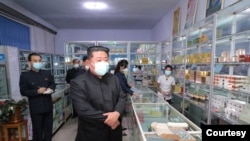 朝鲜官方2022年5月15日公布的领导人金正恩视察一家药店的情形。(朝中社)
