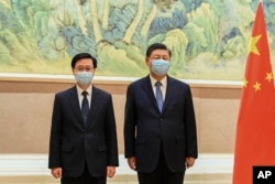 资料照:中国领导人习近平在北京会见新当选的香港特首李家超。(2022年5月30日)