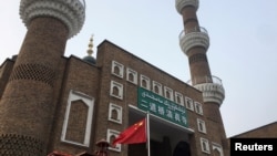 资料照:中国国旗在新疆乌鲁木齐一所清真寺的外面飘扬。(2019年1月3日)