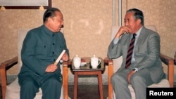 资料照片:1987年,中国前副总理习仲勋(左)在北京与达赖喇嘛的胞兄嘉乐顿珠交谈。