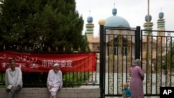 2014年7月17日,维吾尔族居民聚集在中国西部新疆阿克苏市的清真寺外。