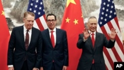美国财政部长姆努钦(中)与贸易代表莱特希泽(左)在北京会晤前,中国副总理刘鹤(右)与他交谈时的手势。(2019年5月1日)