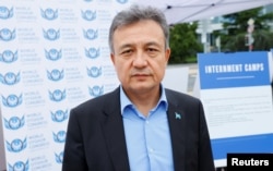 在联合国日内瓦总部外,世界维吾尔代表大会主席多里昆·艾沙站在得到美国政府支持的图片展前,该图片展反映据称被关押在中国新疆拘留营或失踪的维吾尔人。(2021年9月16日)