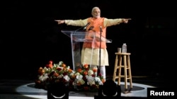 India's Prime Minister Narendra Modi gestures while speaking at Madison Square Garden in New York, during a visit to the United States, Sept. 28, 2014.
