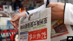 一个中国人拿着《环球时报》,2010年。(资料图)
