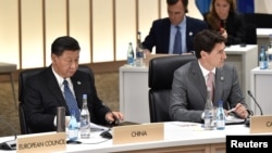 资料照:中国领导人习近平与加拿大总理特鲁多在日本大阪举行的G20峰会上。(2019年6月29日)