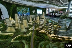 中国房地产公司碧桂园在马来西亚投资的“森林城市”项目模型,有人参观(2016年4月19日)。
