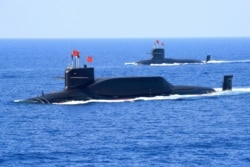 资料照:中国海军094A晋级弹道导弹战略核潜艇在南中国海参加军事表演。(2018年4月12日)