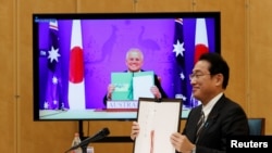澳大利亚总理莫里森和日本首相岸田文雄2022年1月6日签署澳日防务互惠准入协定(RAA)(路透社)