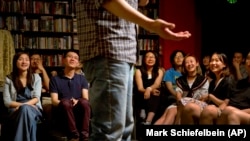 在这张2015年5月24日的照片里,观众在观看一个书店里举办的脱口秀表演