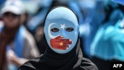 资料照:一名戴着面具的示威者在中国驻伊斯坦布尔领事馆前抗议中国的新疆少数民族政策。(2018年7月5日)